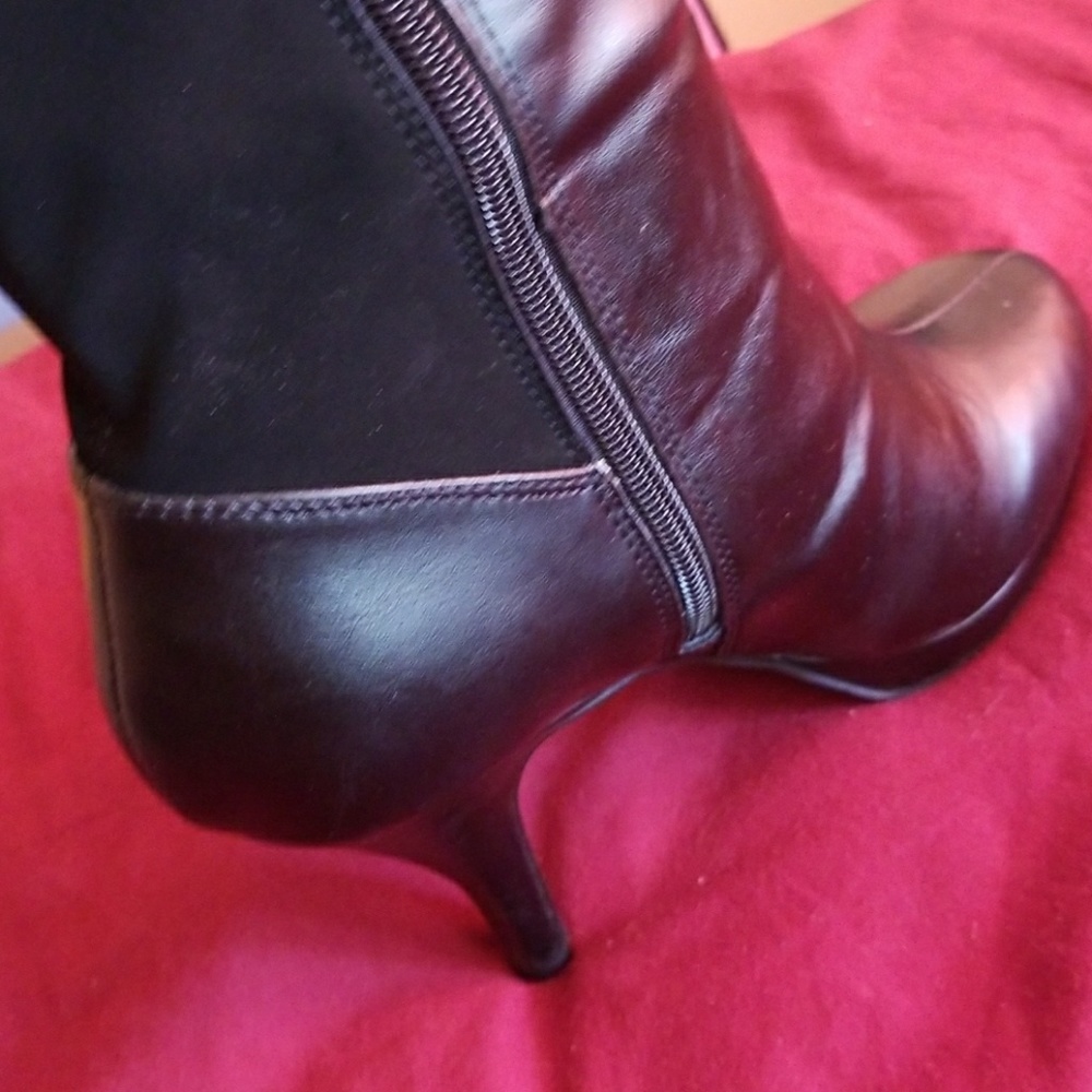 Unlisted knee high black platform boots.